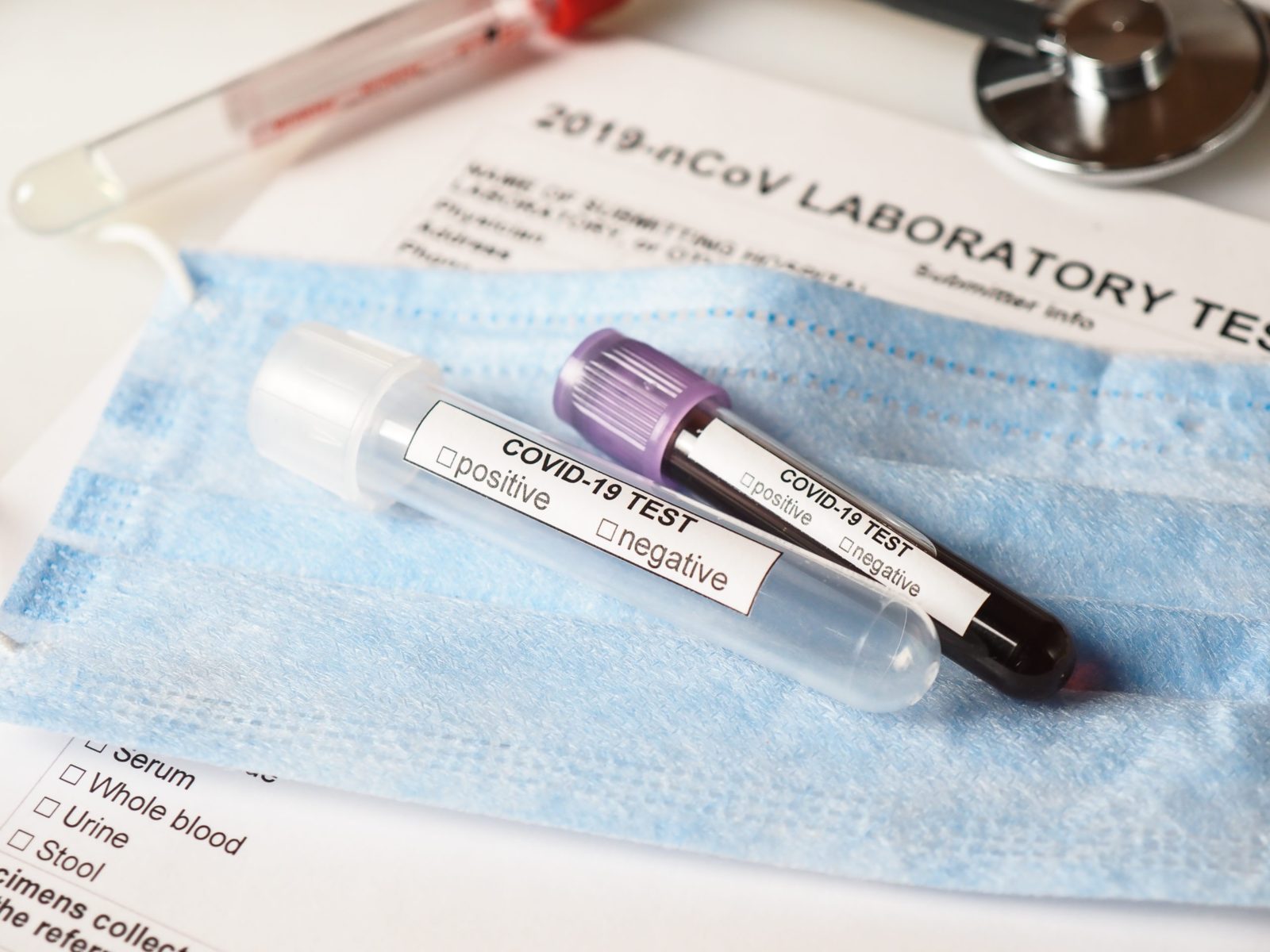 Coronavirus COVID-2019 test concept with blood test tubes, test form and other medical objects